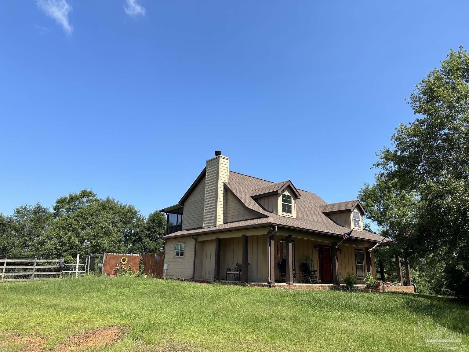 a front view of a house with a garden