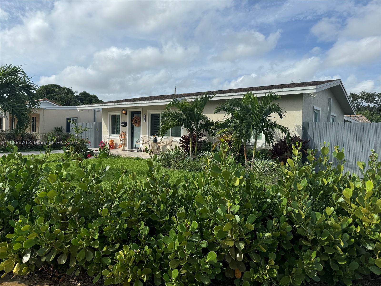 a front view of house with yard and outdoor seating