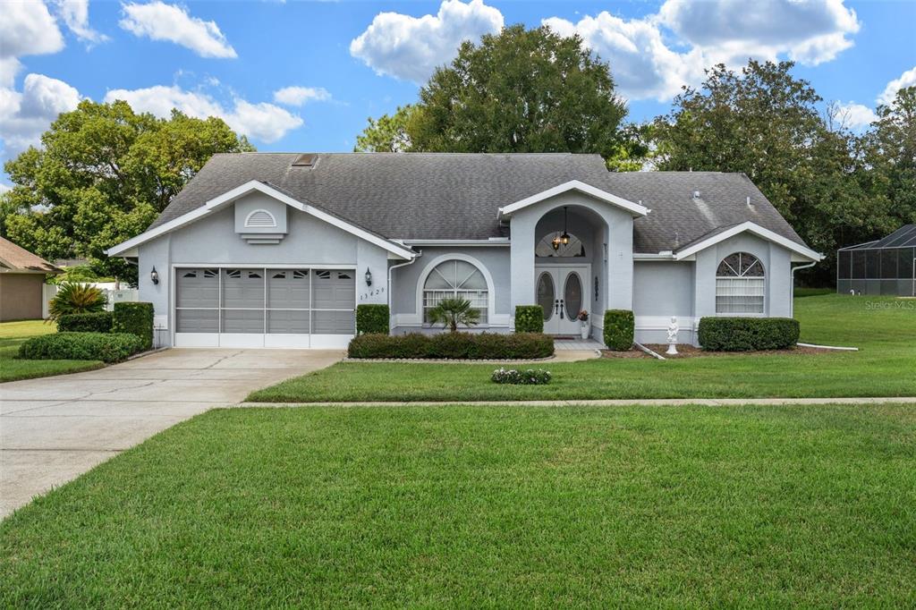 a front view of a house with a yard and garage