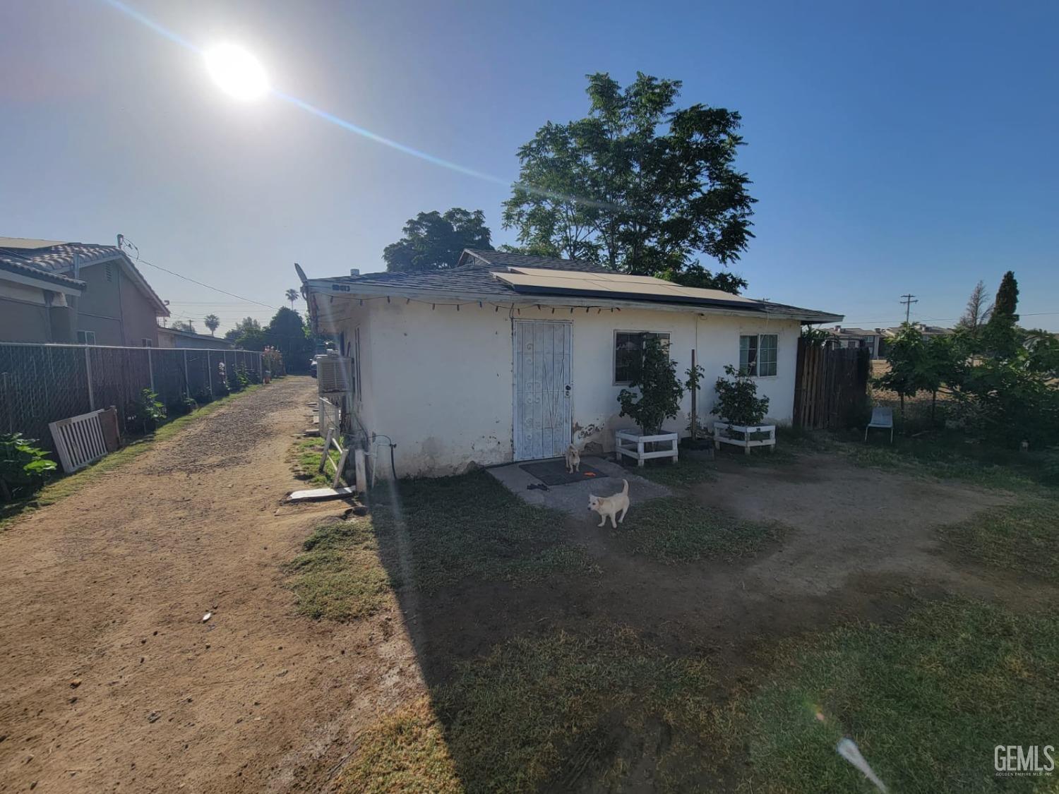 a backyard of a house with table and chairs