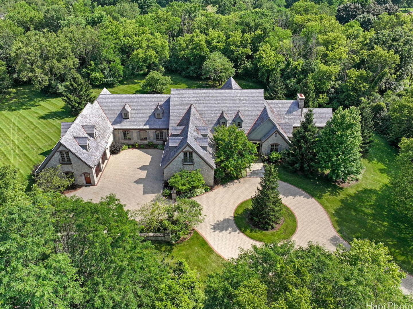 an aerial view of a house with garden space and street view