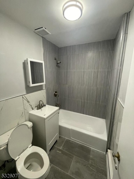 a bathroom with a toilet a sink and bathtub