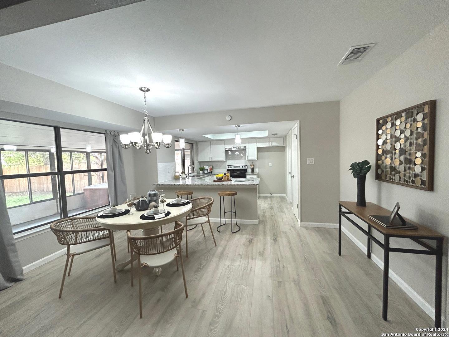 a kitchen with a table and chairs in it