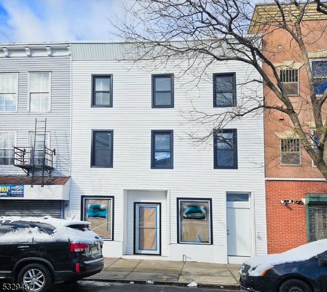 a front view of a house with parking space