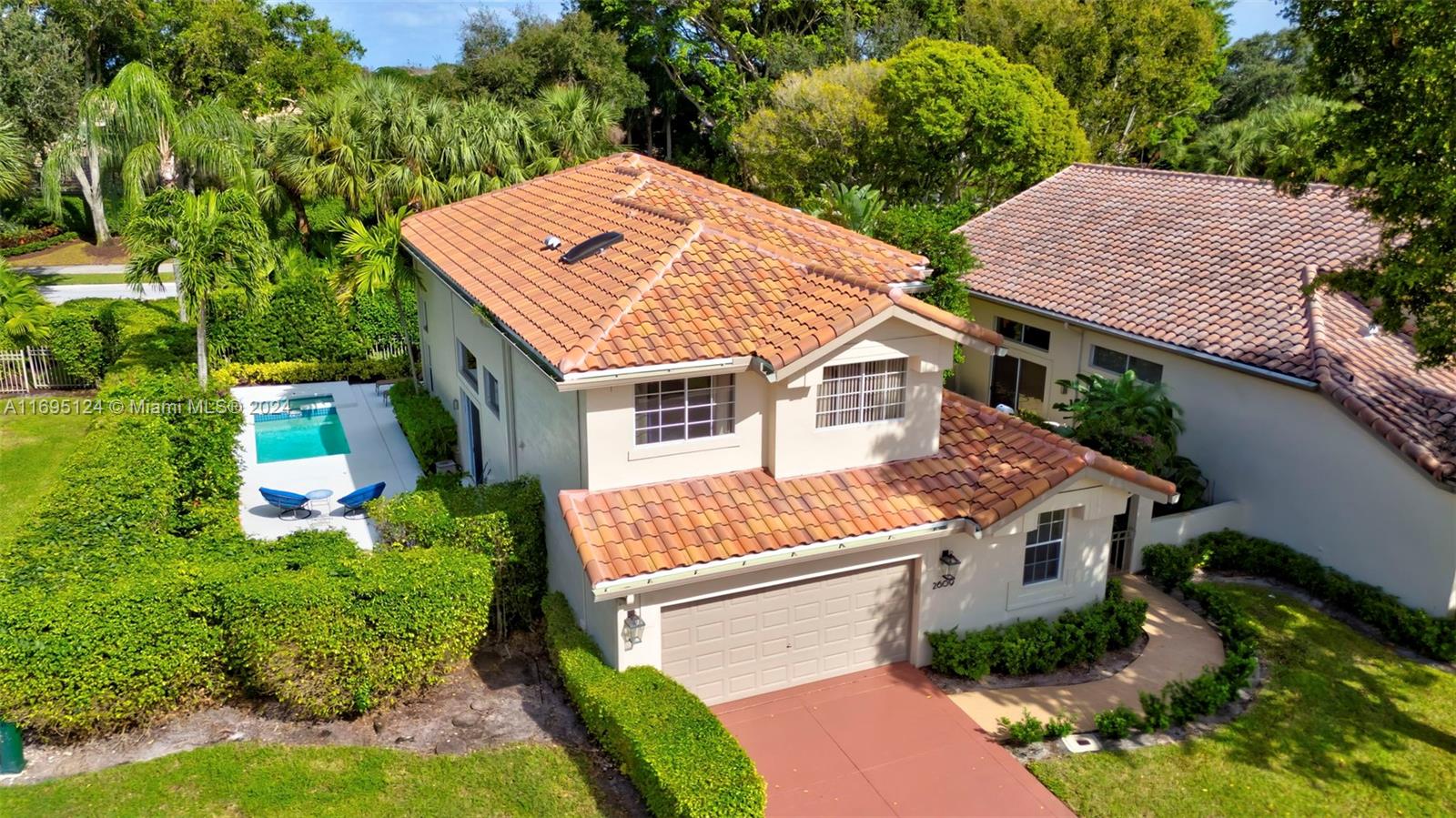 an aerial view of a house with a yard and plants