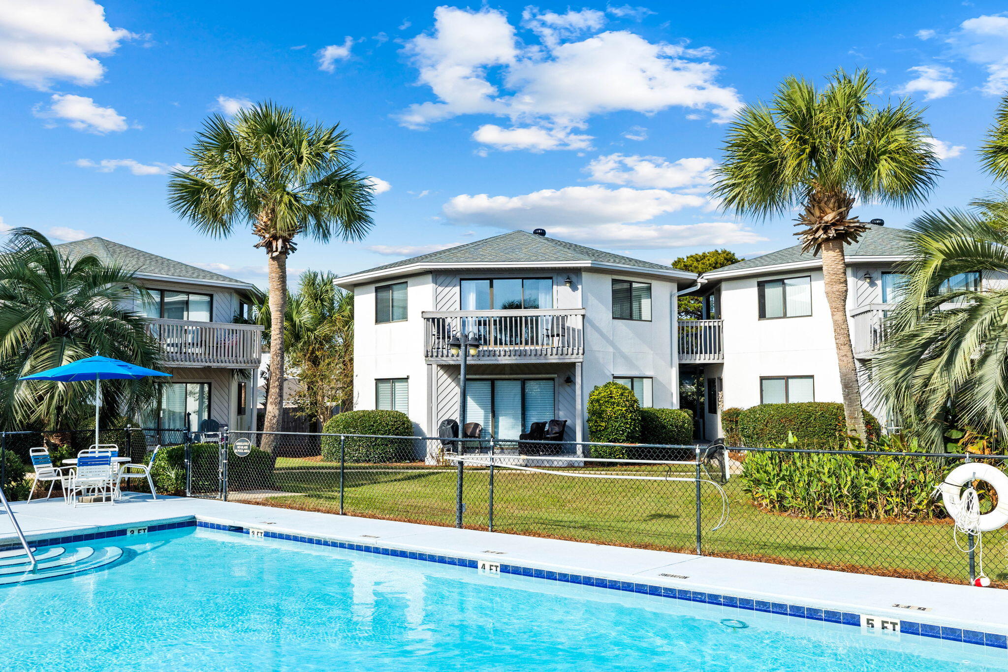 a view of a house with swimming pool and sitting area