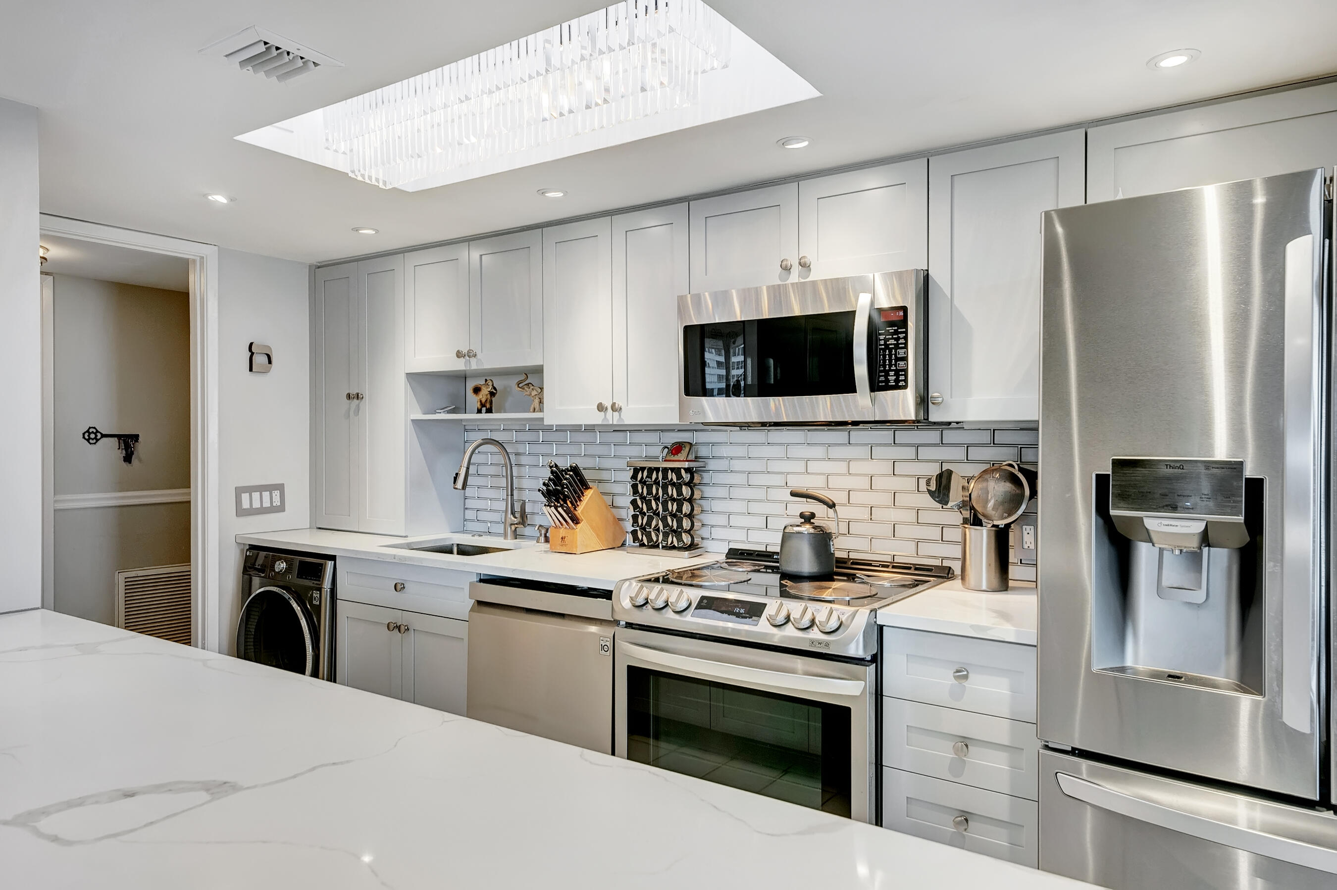 a kitchen with stainless steel appliances a stove microwave and a refrigerator