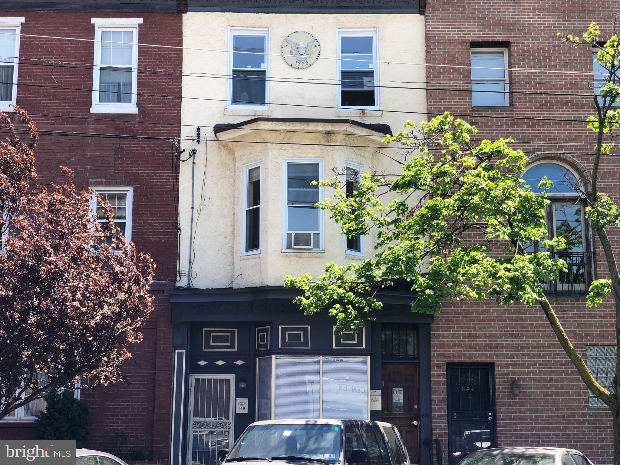 a front view of a building with a garden