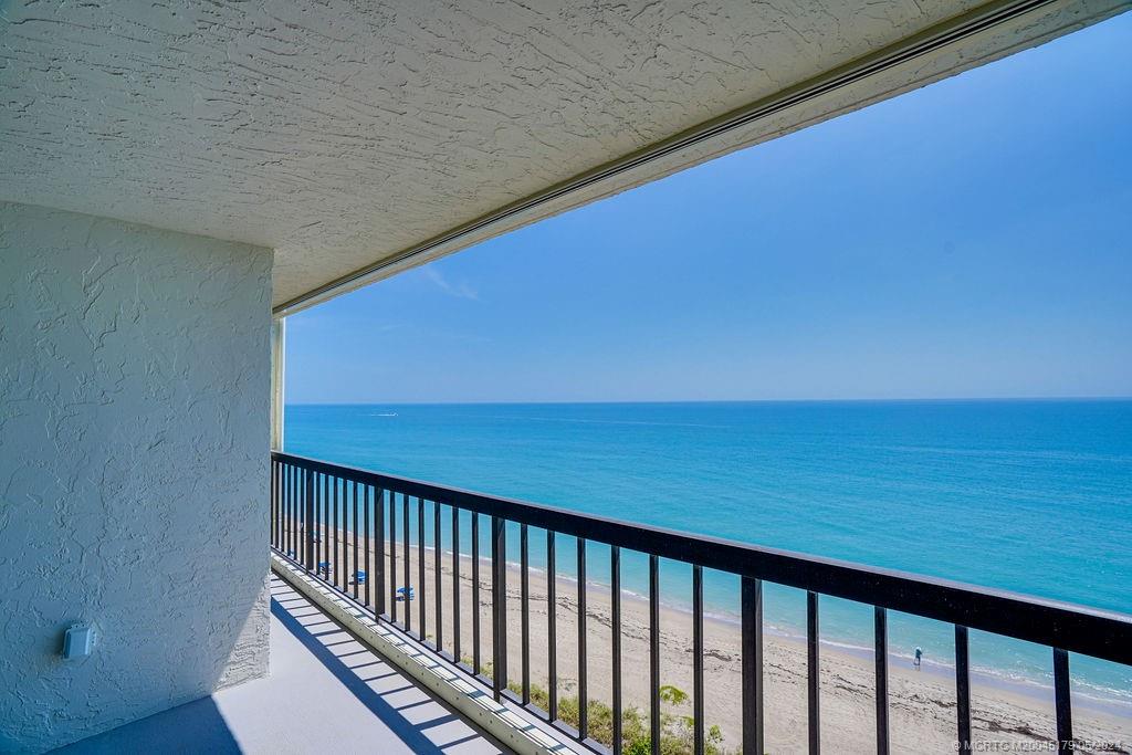 a view of balcony with wooden floor