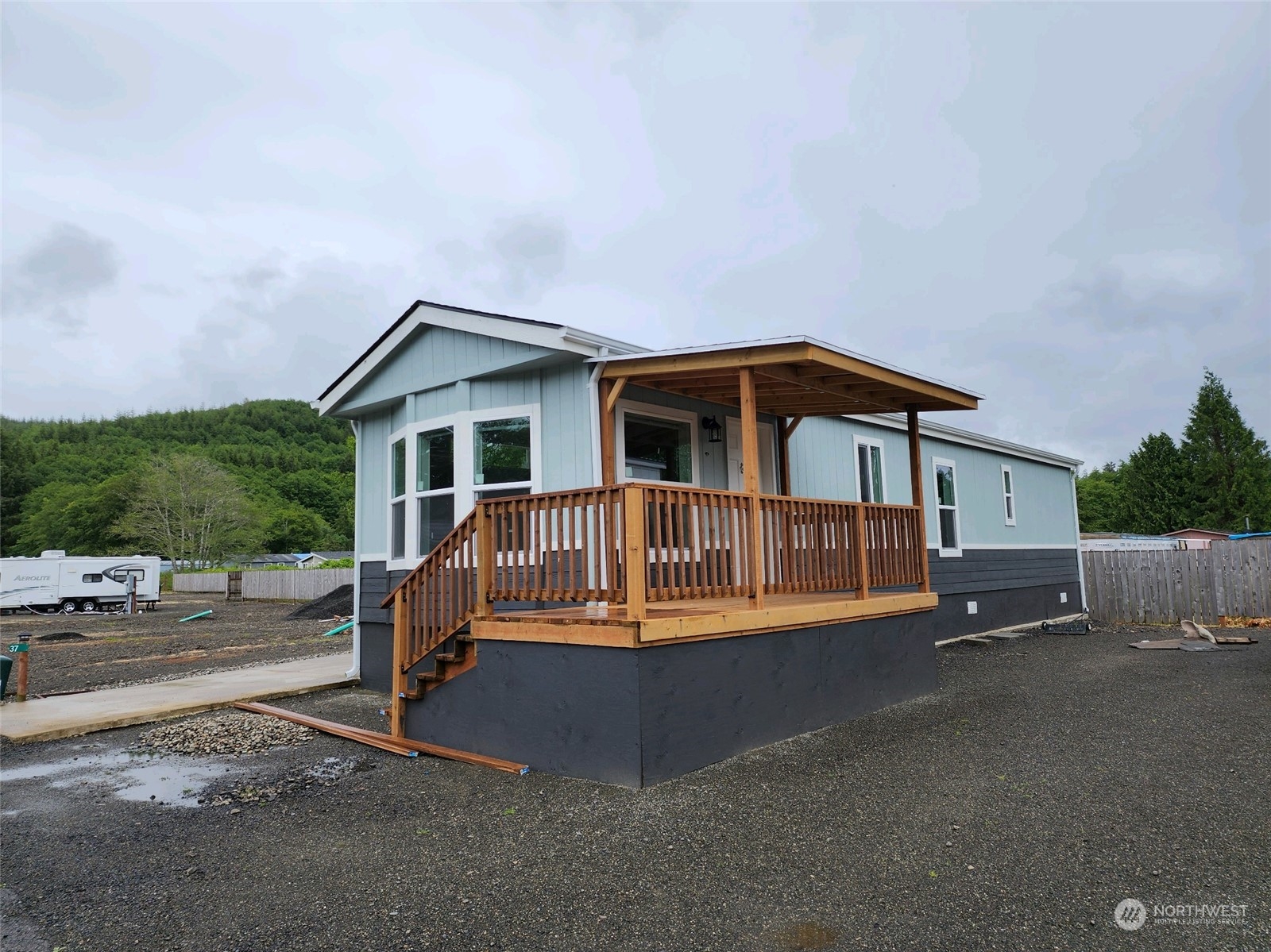 a view of a house with a yard and deck