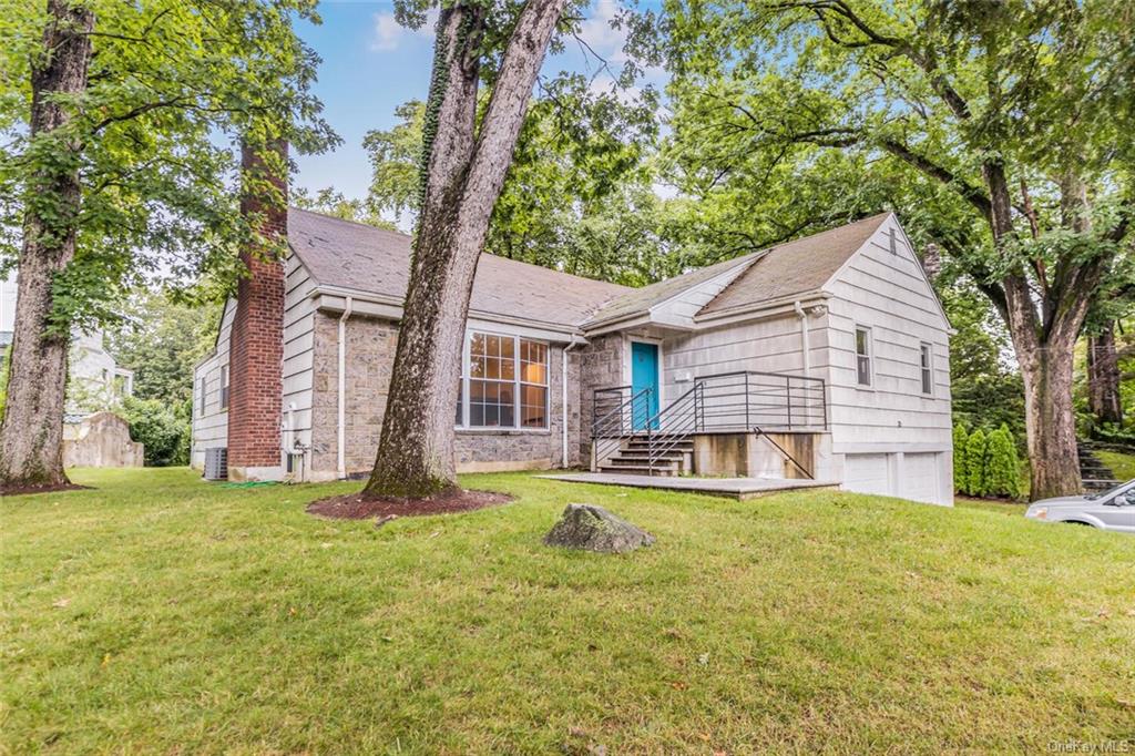 View of front of home featuring a front lawn and a garage