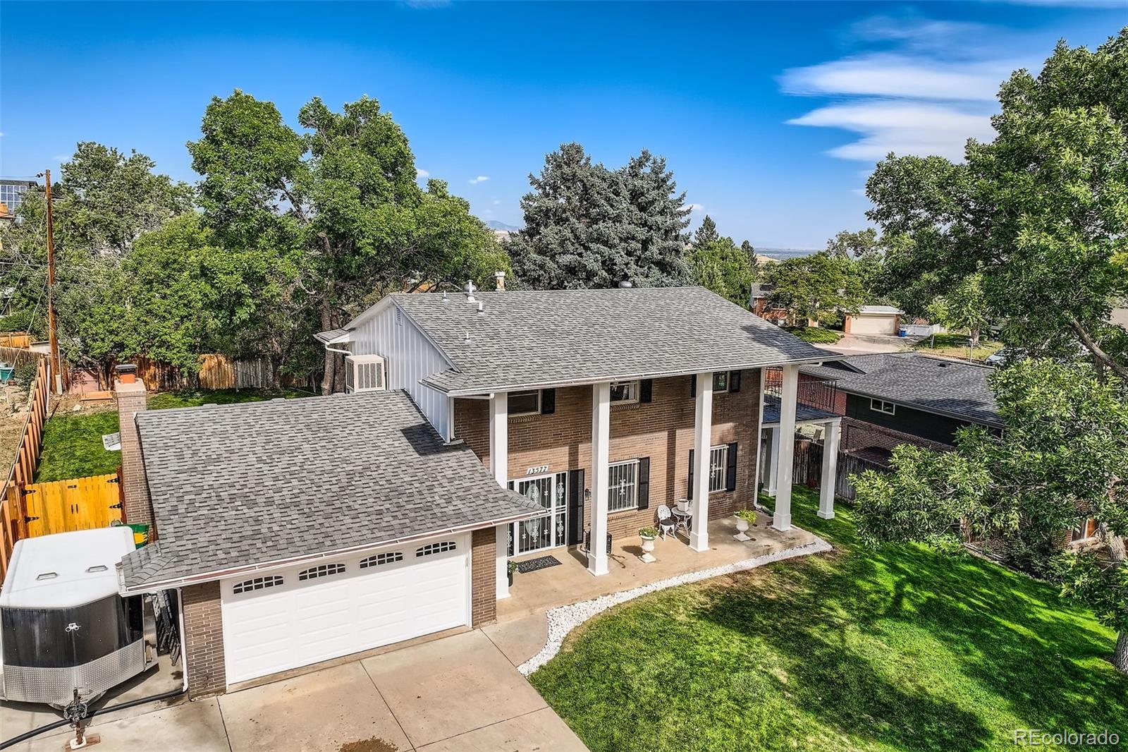 an aerial view of a house with swimming pool garden and patio