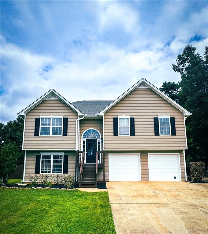 a front view of house with yard and green space