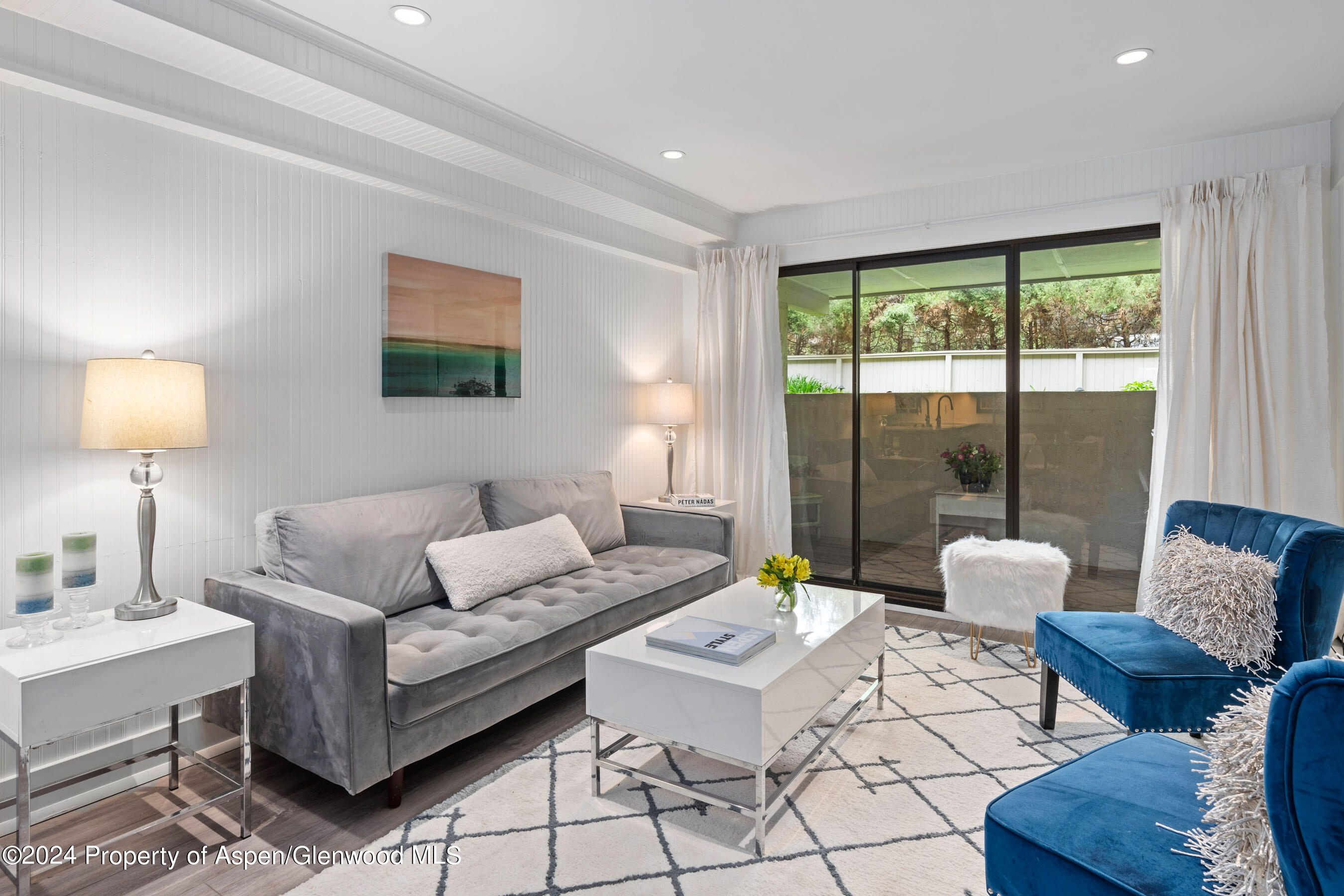 a living room with furniture and a lamp