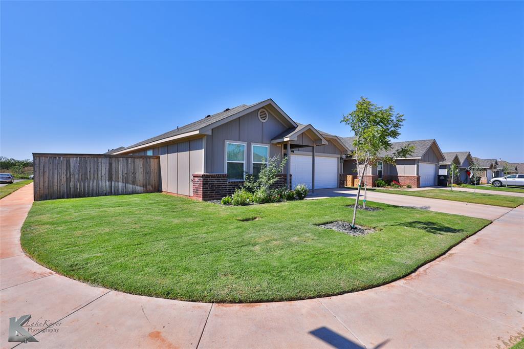 View of front of property with a front yard and a garage