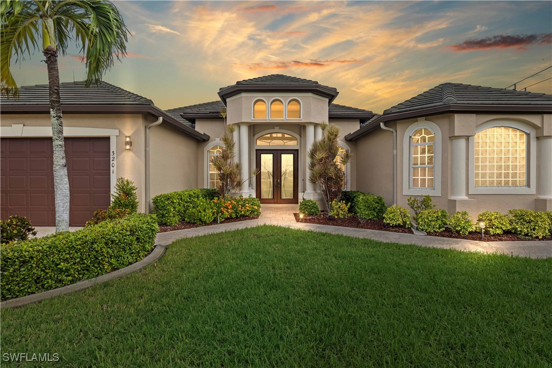 a front view of a house with a garden