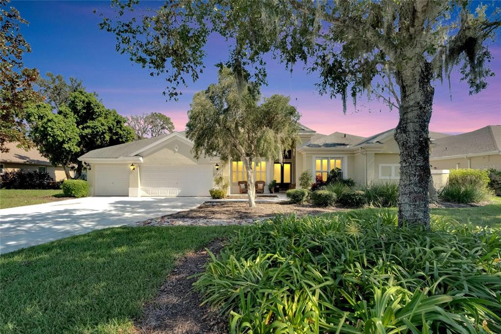 a view of a house with a yard and tree s