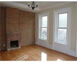 a view of empty room with a fireplace