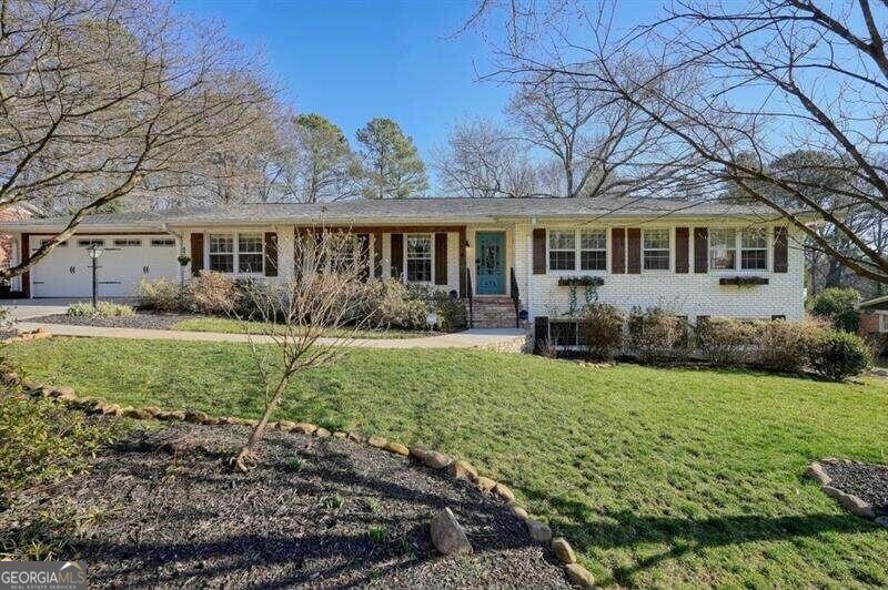 a front view of house with yard and green space