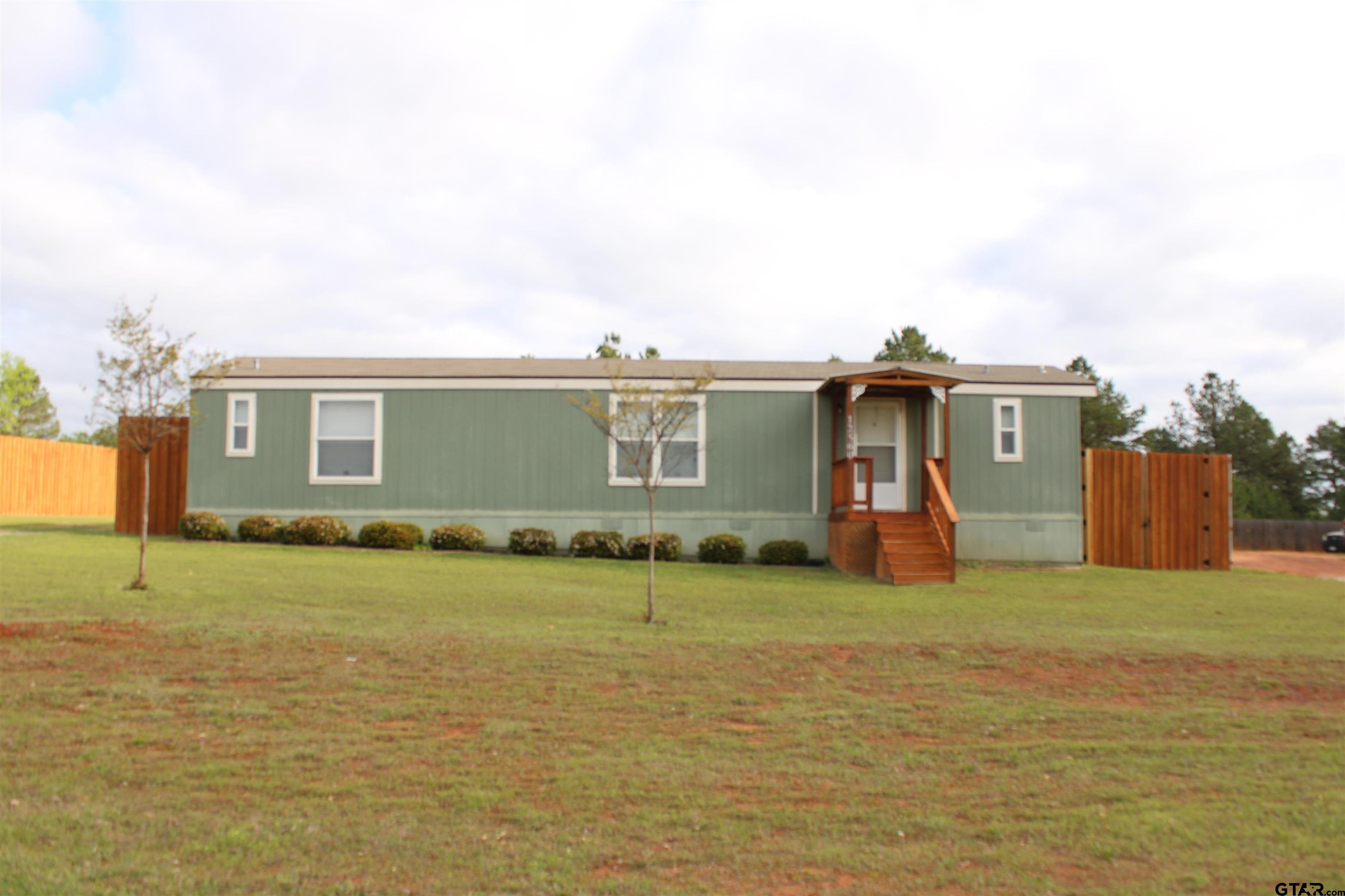 a view of a house with a yard and a window