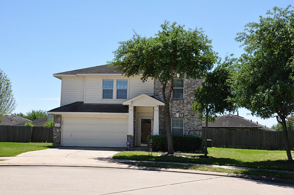 a front view of a house with yard and trees