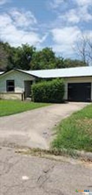 a view of house with swimming pool and yard