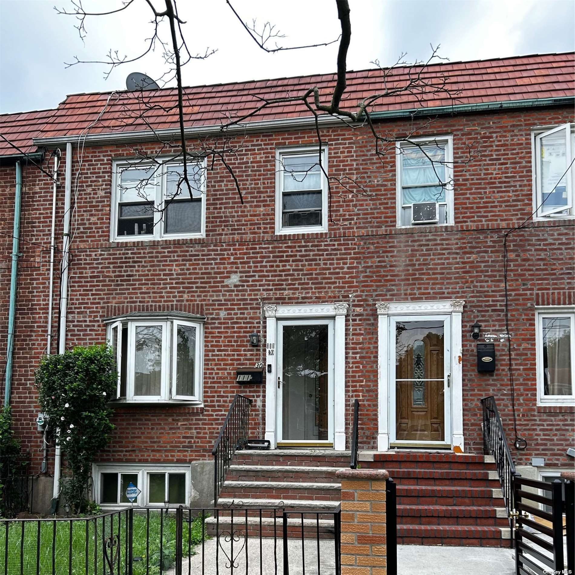 a view of a brick house with large windows