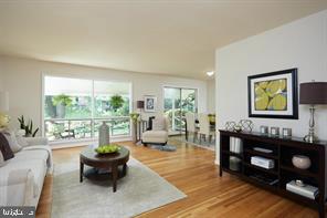 a living room with furniture and a floor to ceiling window