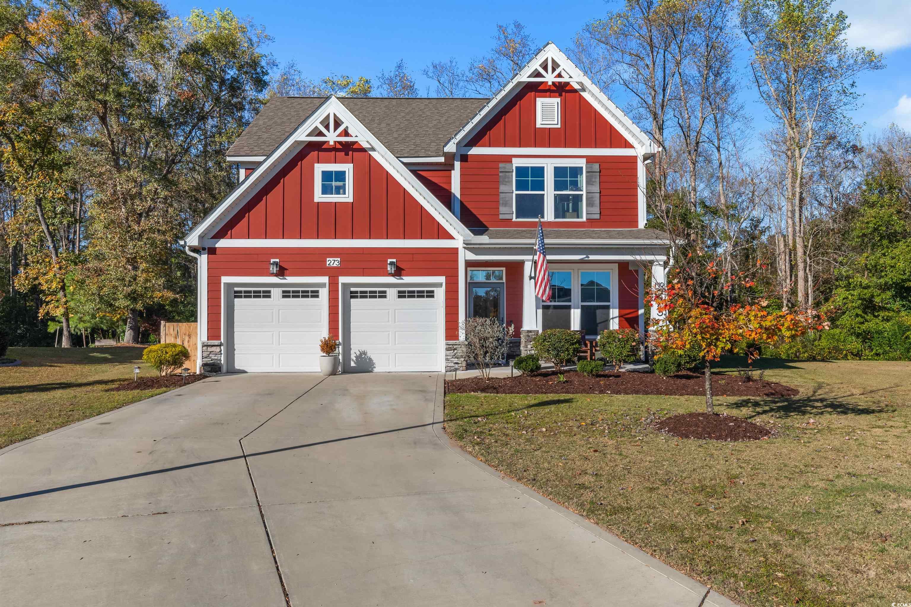 Craftsman-style home featuring a garage and a fron