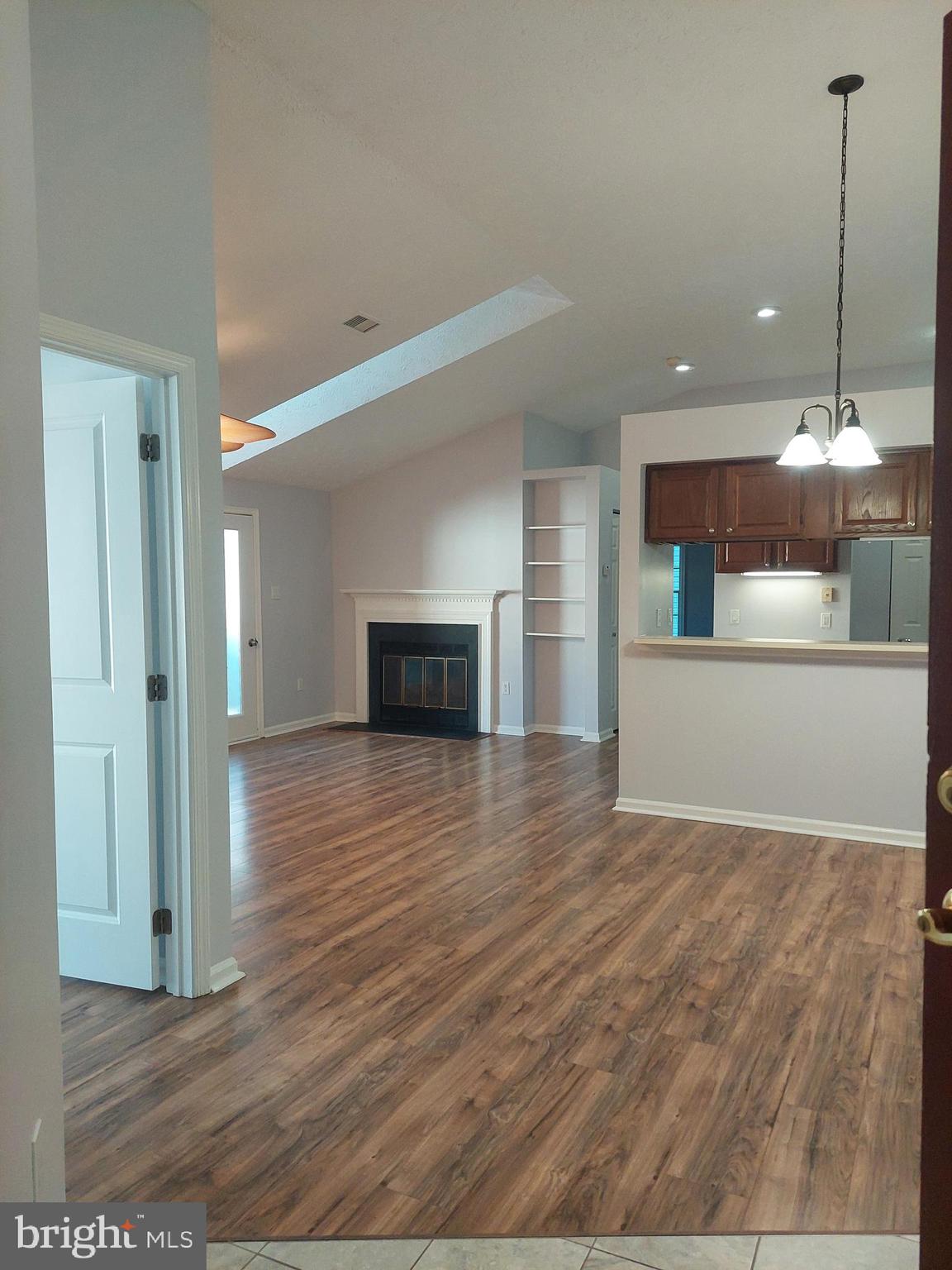 a view of a kitchen with a sink and a fireplace