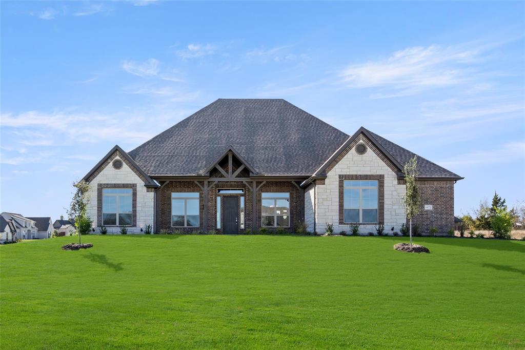 a front view of house with yard and green space