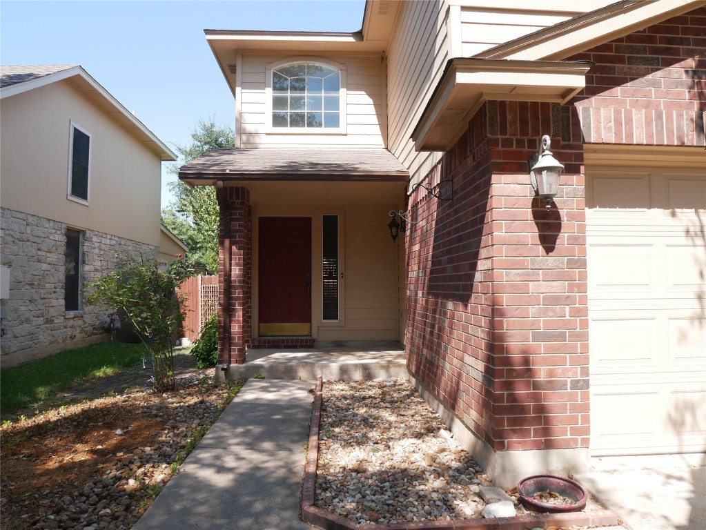 a view of a house with brick walls