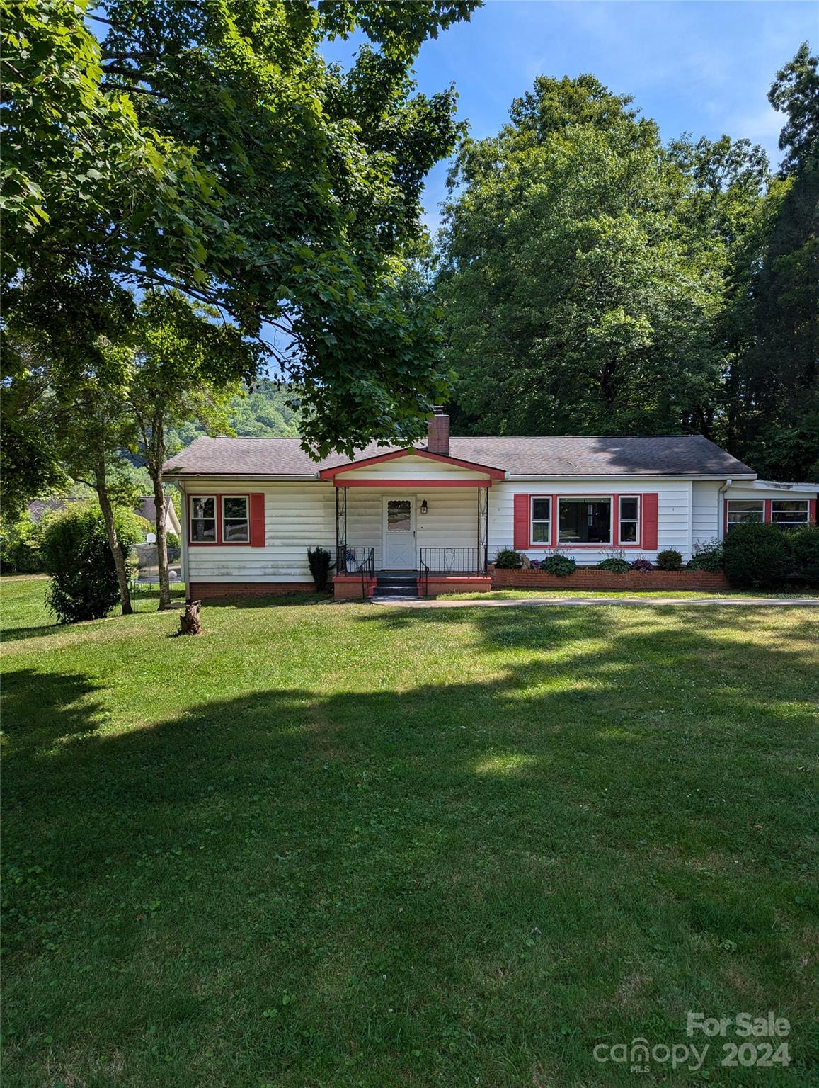 a front view of a house with a garden