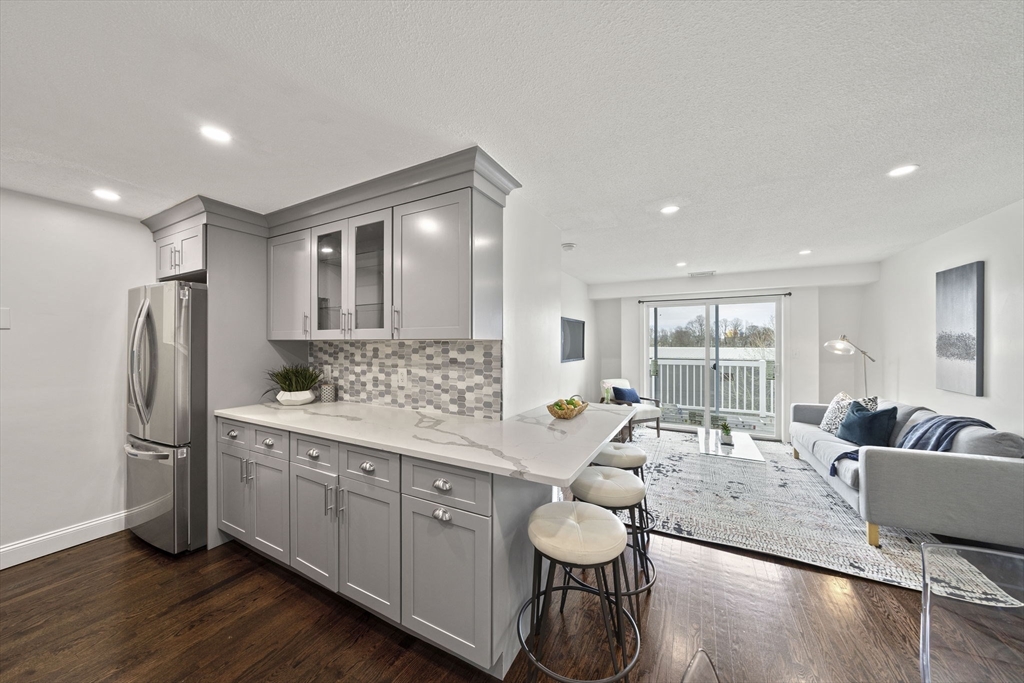 a kitchen with a refrigerator and a sink