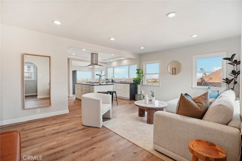 a living room with furniture and view of kitchen