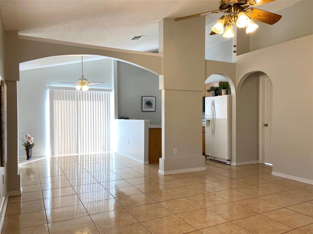 a view of a kitchen with a sink and a chandelier fan