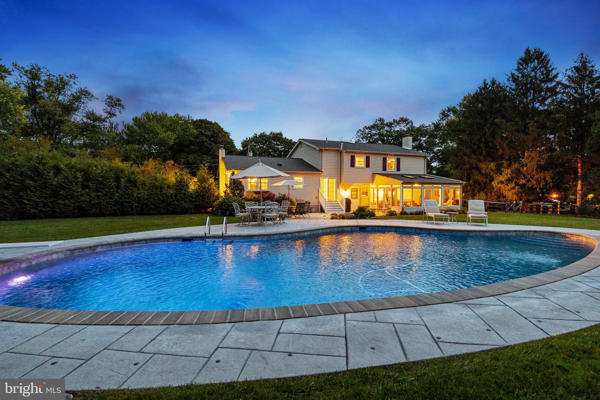 a view of a swimming pool with an outdoor space and seating area