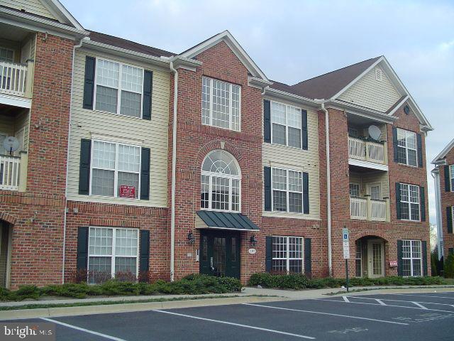 a view of a brick building next to a yard