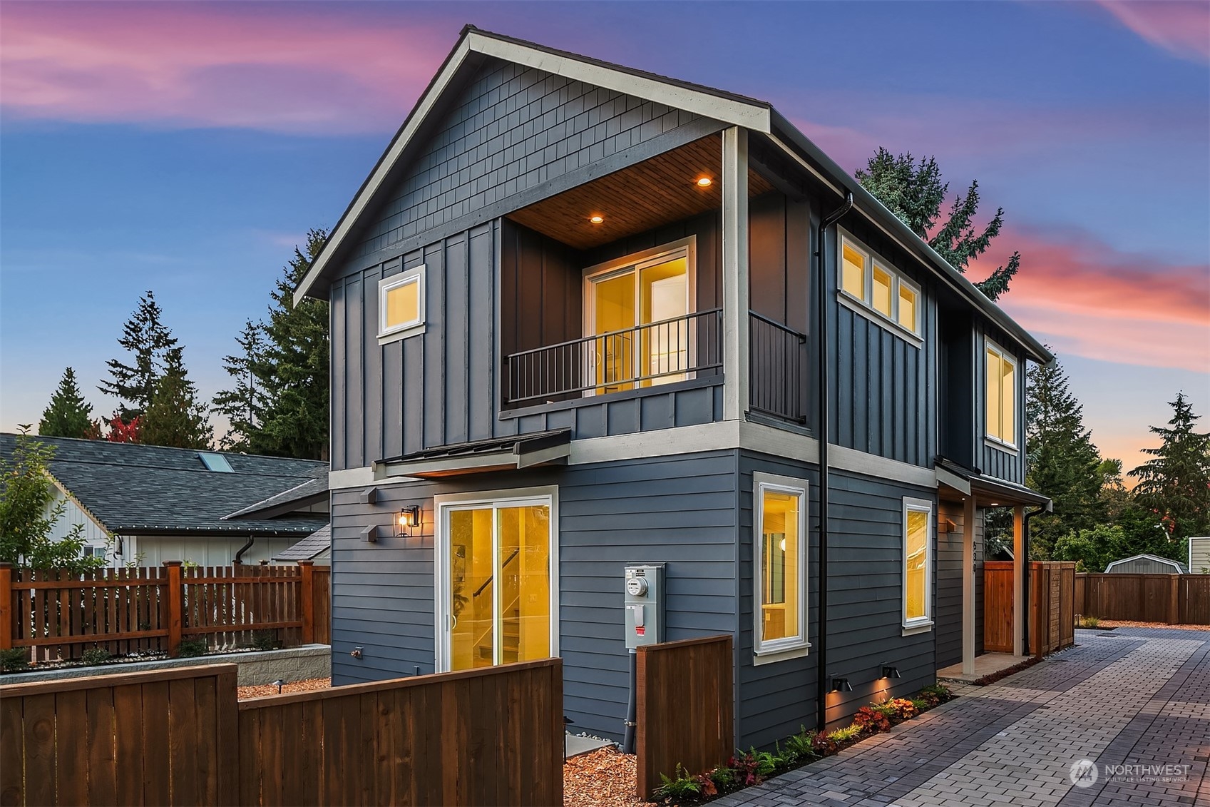 a view of residential house with wooden fence