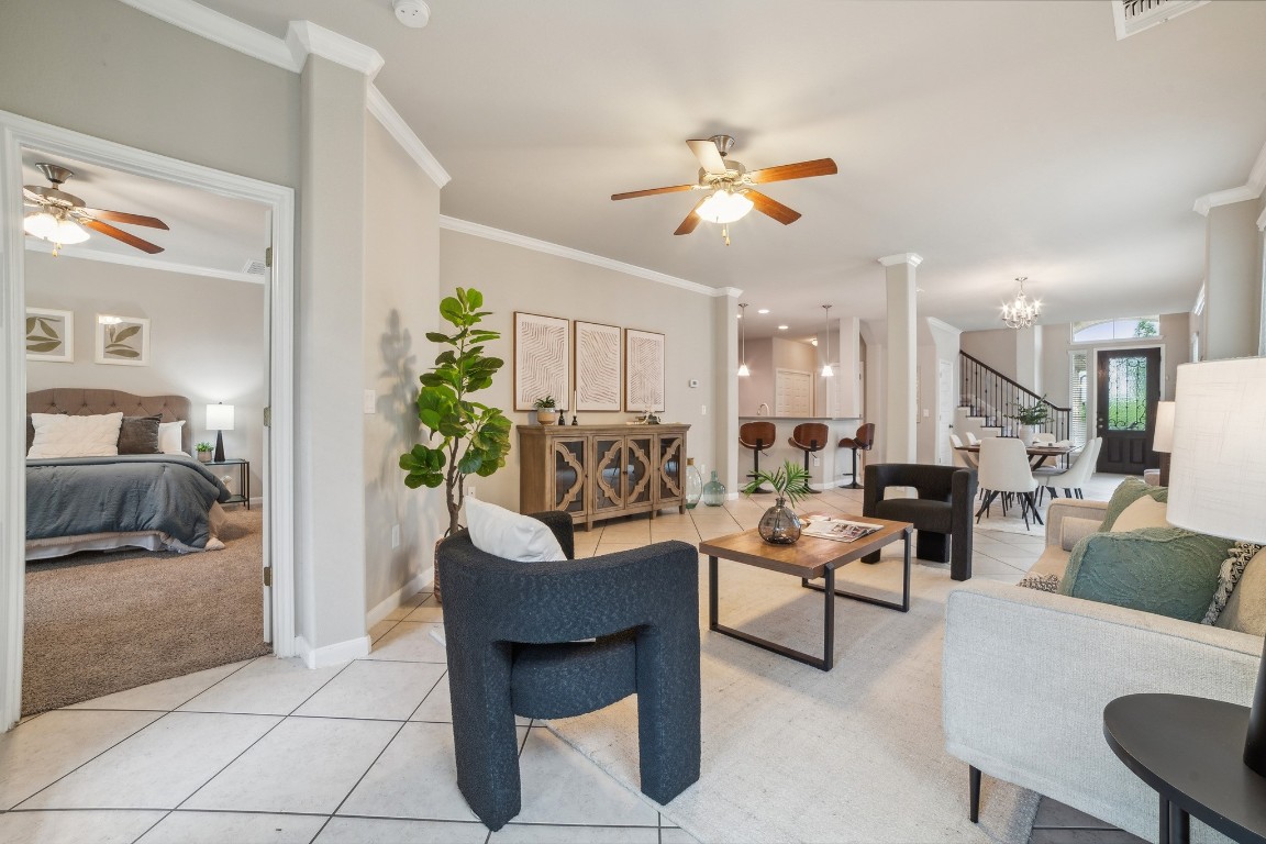 a living room with furniture and a chandelier