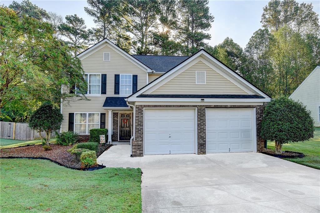 a front view of a house with a yard and garage