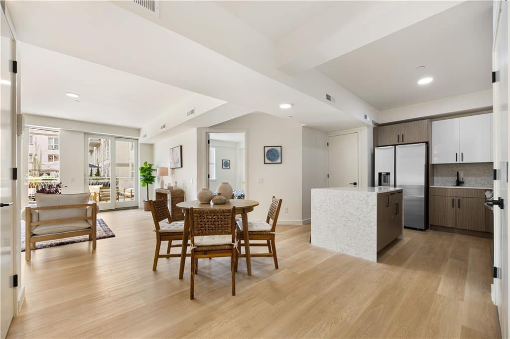 a view of a dining room kitchen with furniture and wooden floor