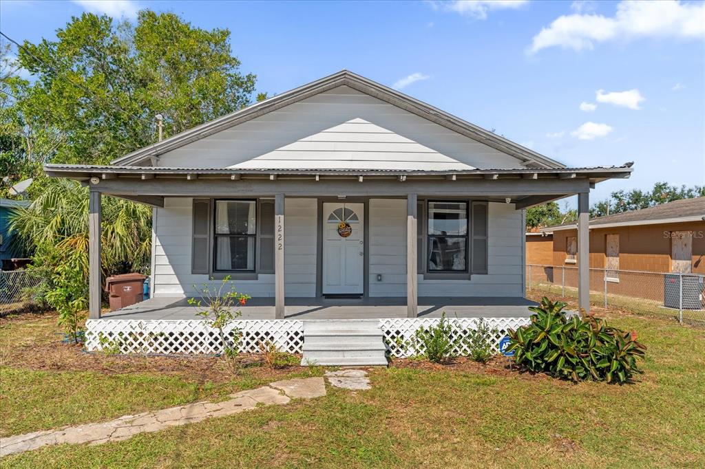 a front view of a house with a yard outdoor seating and barbeque oven