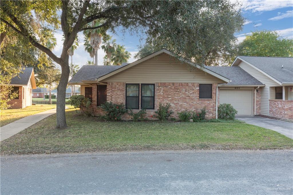 House featuring a garage and a front yard