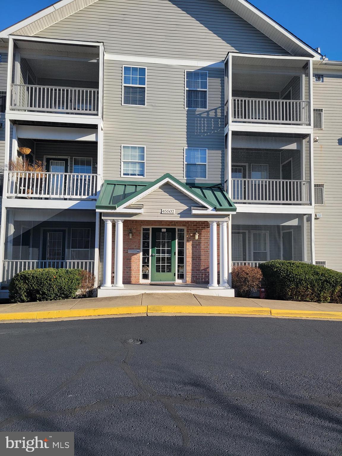 a front view of an apartment with a yard