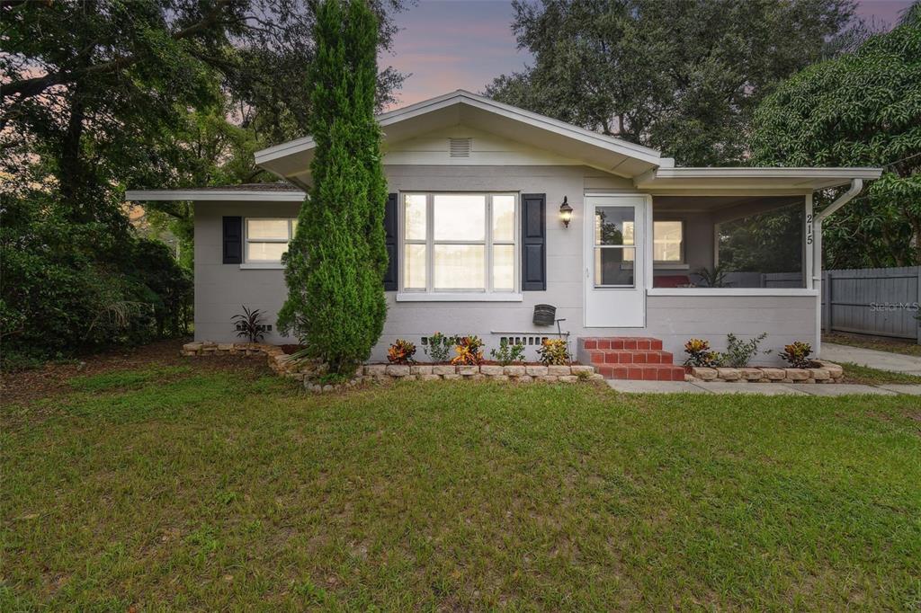 a front view of house with yard and green space