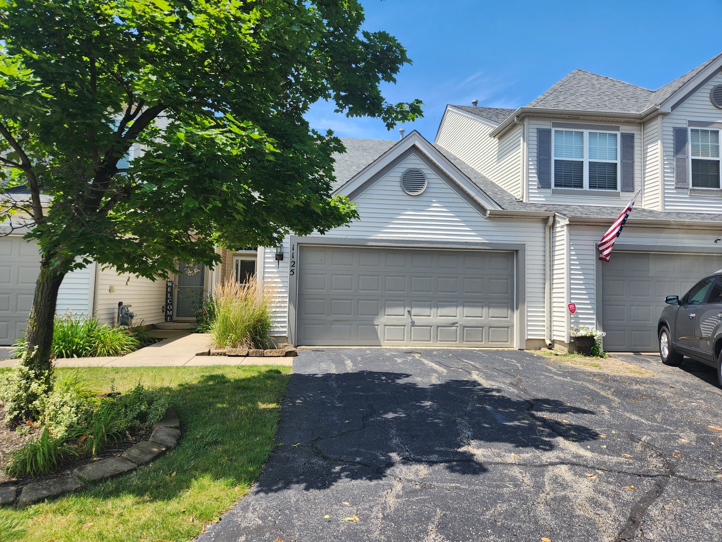 a front view of a house with a yard and garage