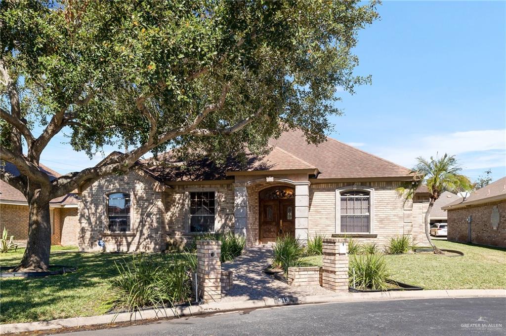 front view of a house with a tree