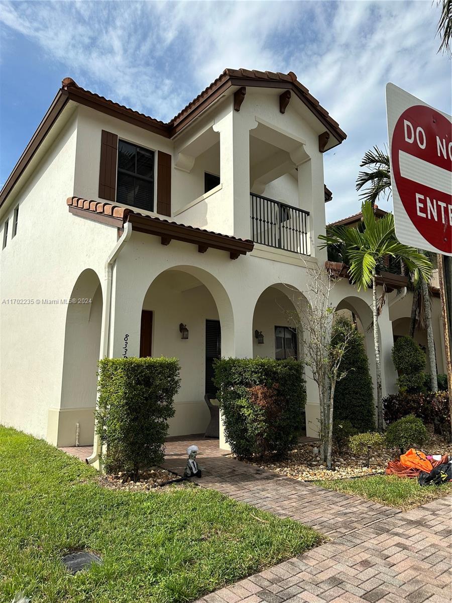 a front view of a house with garden