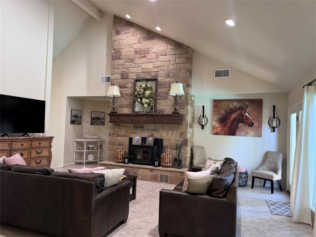 a living room with fireplace furniture and a flat screen tv